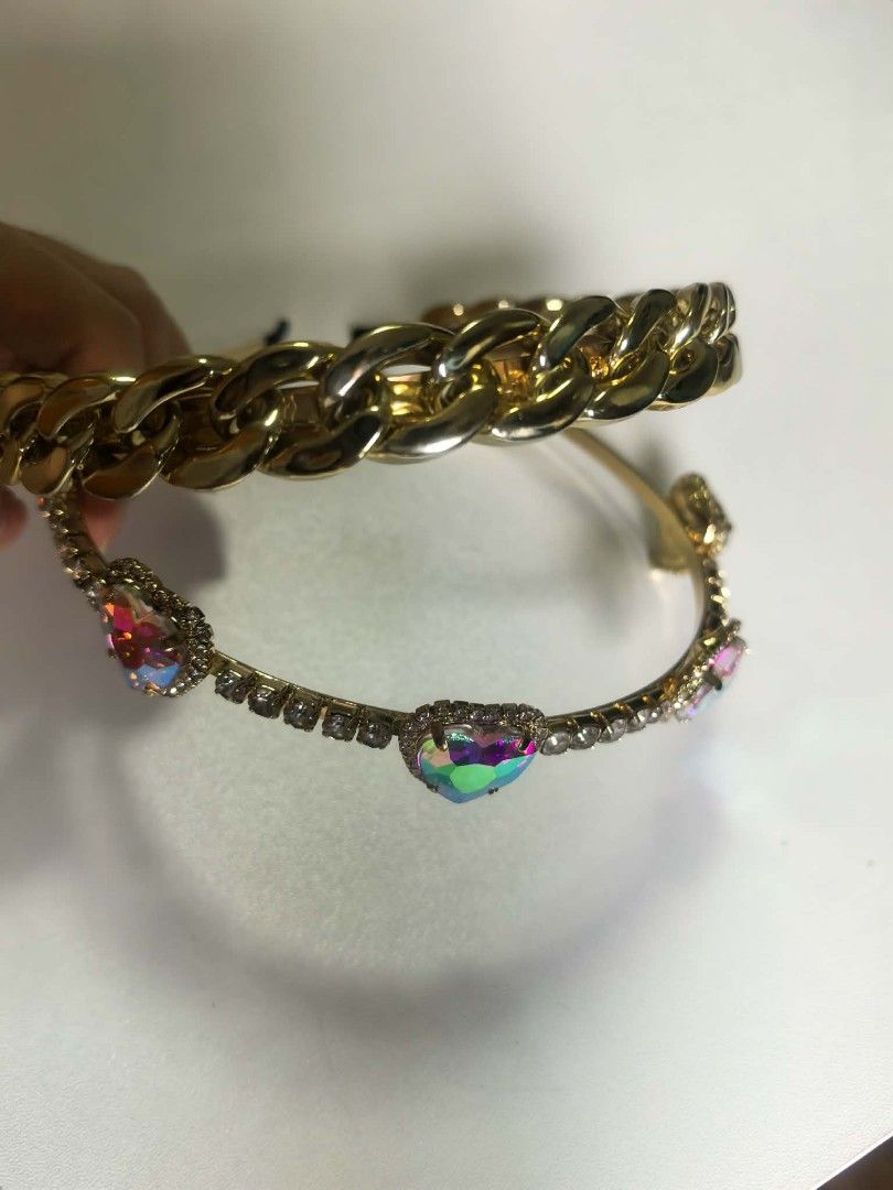 2forP150 Gold Chain & Heart Gem Headbands Set (Category: Hair Accessories) located in Manila. Submitted by aquarianworld (Listing ID 1463967200, Image 3). Description: - Set of two cute gold-toned headbands. - Headband 1: Features a stylish chunky gold chain design. - Headband 2: Adorned with sparkly rhinestones and colorful heart gems. - Instantly adds flair to any outfit. - Ideal for parties, special occasions, or casual dressing up..