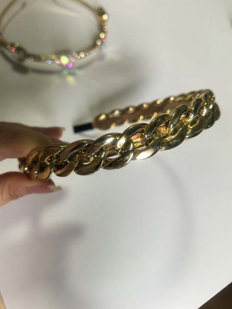 2forP150 Gold Chain & Heart Gem Headbands Set (Category: Hair Accessories) located in Manila. Submitted by aquarianworld (Listing ID 1463967200, Image 1). Description: - Set of two cute gold-toned headbands. - Headband 1: Features a stylish chunky gold chain design. - Headband 2: Adorned with sparkly rhinestones and colorful heart gems. - Instantly adds flair to any outfit. - Ideal for parties, special occasions, or casual dressing up..