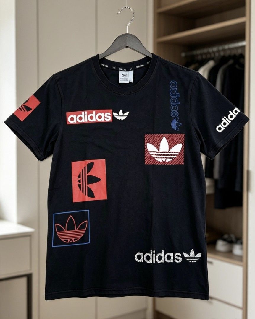 Adidas Black Graphic T-Shirt (Category: Tshirts & Polo Shirts ) located in Manila. Submitted by noblehorse-dccec0 (Listing ID 1464072626, Image 1). Description: - Classic black Adidas t-shirt - Features multiple graphic logos in red, blue, and white - Iconic Adidas branding - Short sleeves dimes: 20x25.