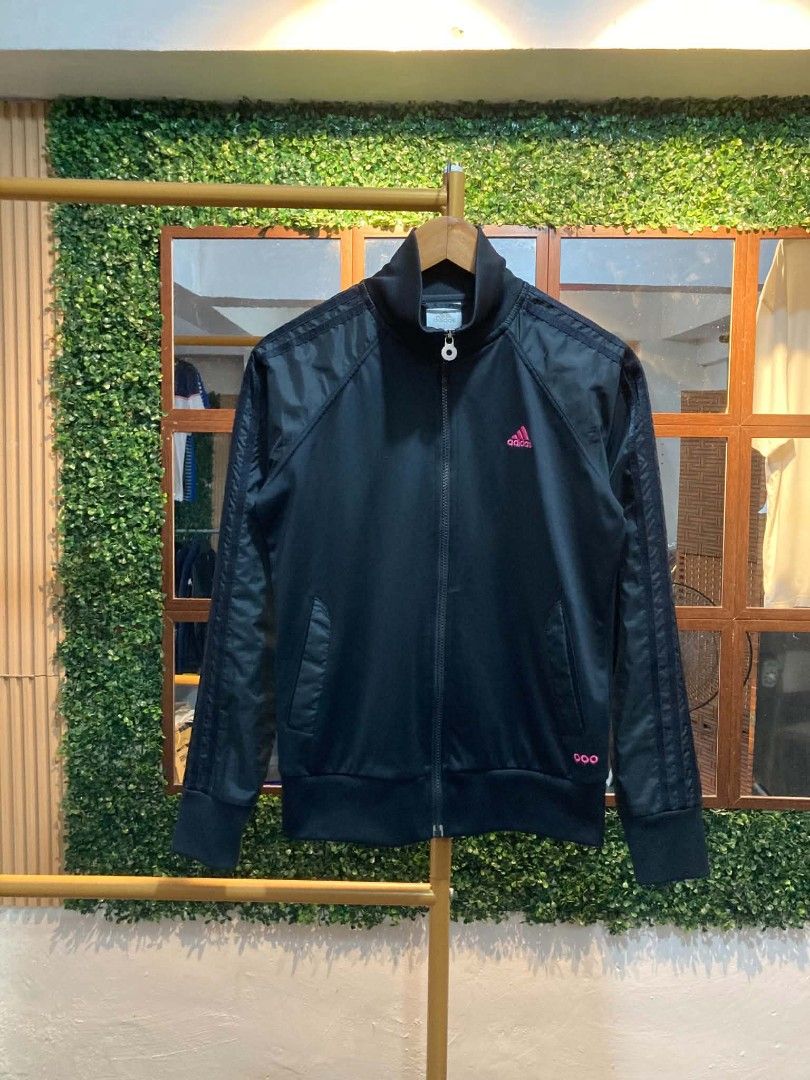 Adidas Black Track Jacket Pink Accents (Category: Coats, Jackets and Outerwear) located in Trece Martires City. Submitted by djaothriftshop (Listing ID 1463973131, Image 1). Description: - Classic black Adidas track jacket - Eye-catching pink accents on logo and sleeves - Full zip closure for easy wear - Convenient front pockets - Comfortable ribbed cuffs and hem - Perfect for casual outings or athletic activities.