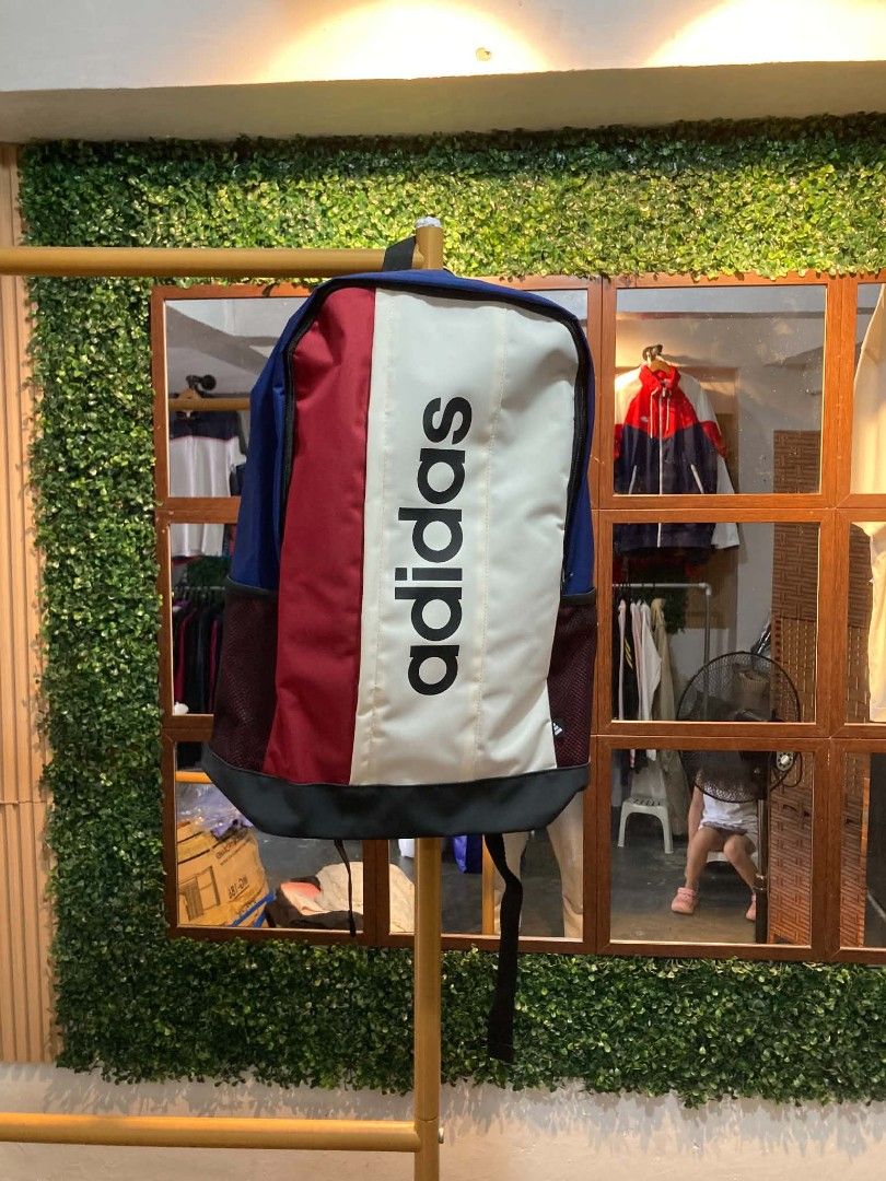 Adidas Colorblock Backpack (Category: Backpacks) located in Trece Martires City. Submitted by djaothriftshop (Listing ID 1463973584, Image 1). Description: - Stylish Adidas backpack with a unique colorblock design. - Features a combination of navy blue, maroon, and cream panels. - Prominent black Adidas logo for a classic look. - Includes convenient side mesh pockets for water bottles or essentials. - Ideal for school, work, or everyday adventure