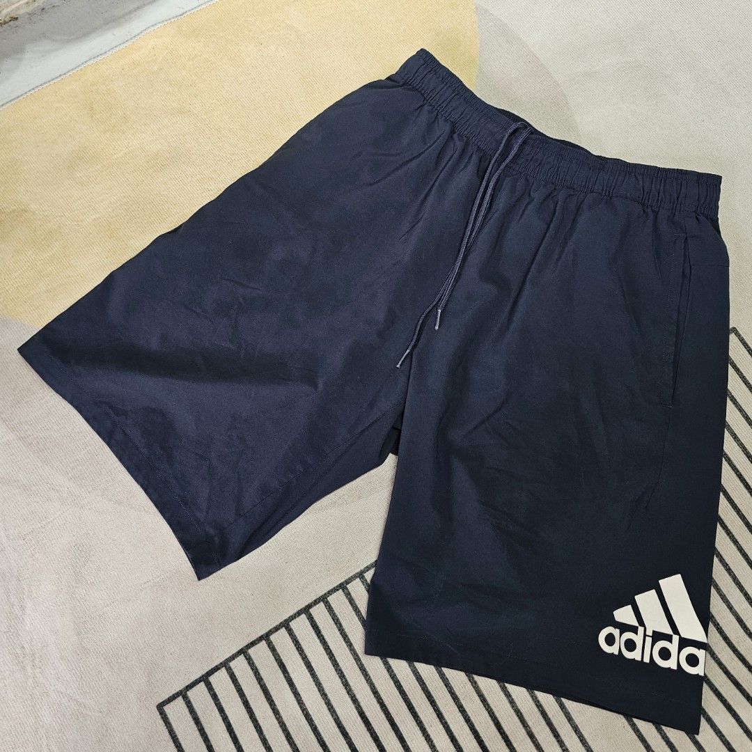 Adidas Navy Shorts (Category: Shorts) located in Baguio. Submitted by kayeonlineshop (Listing ID 1463993342, Image 1). Description: navy blue adidas Run It Shorts featuring an elastic drawstring waistband and the signature logo printed near the lower hem w30-40 L20.5 h24.5.