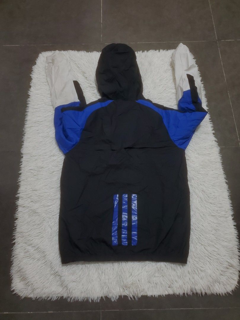 Adidas Neo Windbreaker Jacket Black Blue White (Category: Coats, Jackets and Outerwear) located in Manila. Submitted by royalrabbit.7b2a11 (Listing ID 1464082149, Image 2). Description: - Adidas Neo windbreaker jacket - Color: Black with blue and white accents - Hooded design - Features iconic Adidas three stripes on the back - Lightweight material, perfect for casual wear or sports.