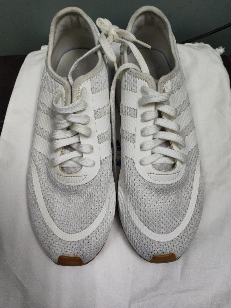 Adidas White Running Sneakers (Category: Sneakers) located in Paranaque City. Submitted by joycelyn10 (Listing ID 1463954039, Image 3). Description: - Classic white Adidas sneakers - Iconic three-stripe design - Breathable mesh upper - Durable rubber sole - Perfect for everyday wear or light workouts - Shows some signs of wear on soles and interior.