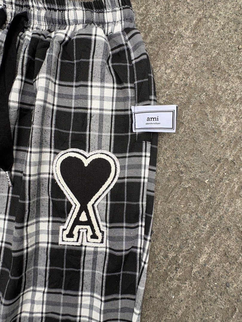 AMI Alexandre Mattiussi Plaid Pants (Category: Trousers) located in Iligan City. Submitted by seddicmoti2002 (Listing ID 1463981786, Image 3). Description: - AMI black and white plaid pants - Features iconic Ami de Coeur logo patch on left leg - Elastic waistband with adjustable drawstring - Cuffed ankles for a stylish finish - Comfortable and perfect for casual outfits.