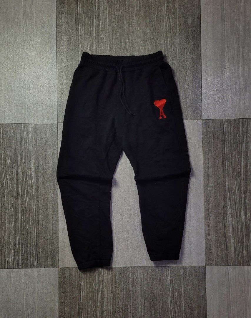 AMI PARIS AMI DE COEUR SWEATPANTS (Category: Joggers) located in Manila. Submitted by 7100treasure.co (Listing ID 1463975829, Image 1). Description: AMI PARIS AMI DE COEUR SWEATPANTS • Color: Black • Size on Tag: Medium • Made in Portugal (With Love) • 100% Organic Cotton construction • Red embroidered Ami de Cœur logo patch below front pocket • Elastic waistband with tonal drawstring adjustment • Elasticated ribbed leg cuffs • Side slit pockets 