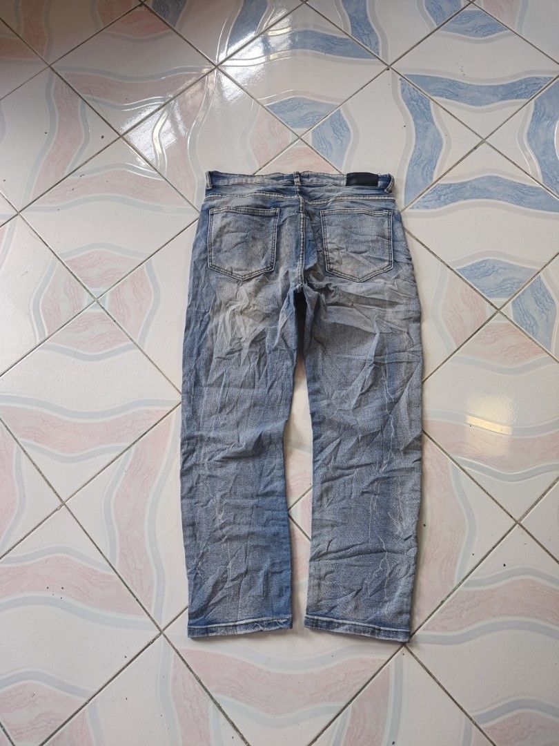 Amiri Style Distressed Blue Denim Jeans (Category: Jeans) located in Legazpi City. Submitted by cookandthriftzzzzz (Listing ID 1464072822, Image 3). Description: - Cool Amiri-style jeans - Light blue wash with distressed details - Prominent 'A' logo on the left leg - 'Amiri' script on the right leg - Straight leg fit - Perfect for a streetwear look - Please check photos for exact details size 34 length 39 excellent missing washtag .