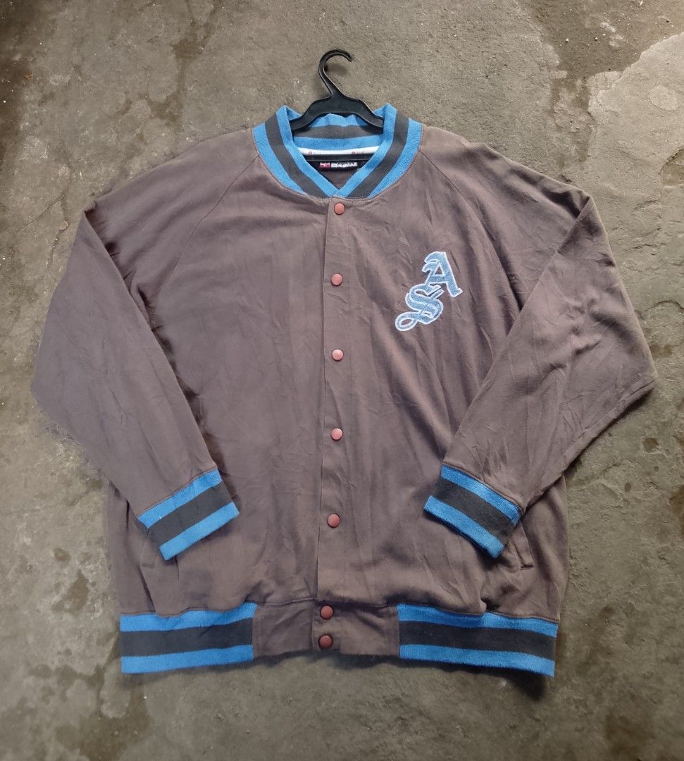 Apart Graffiti Logo Varsity Jacket (Category: Coats, Jackets and Outerwear) located in Manila. Submitted by warmcloud-06f3 (Listing ID 1463995927, Image 3). Description: - Brown varsity jacket - Blue and grey striped cuffs and collar - Large graffiti-style logo on the back - Embroidered 'A' logo on the front left chest - Button-up closure - Perfect for streetwear style.