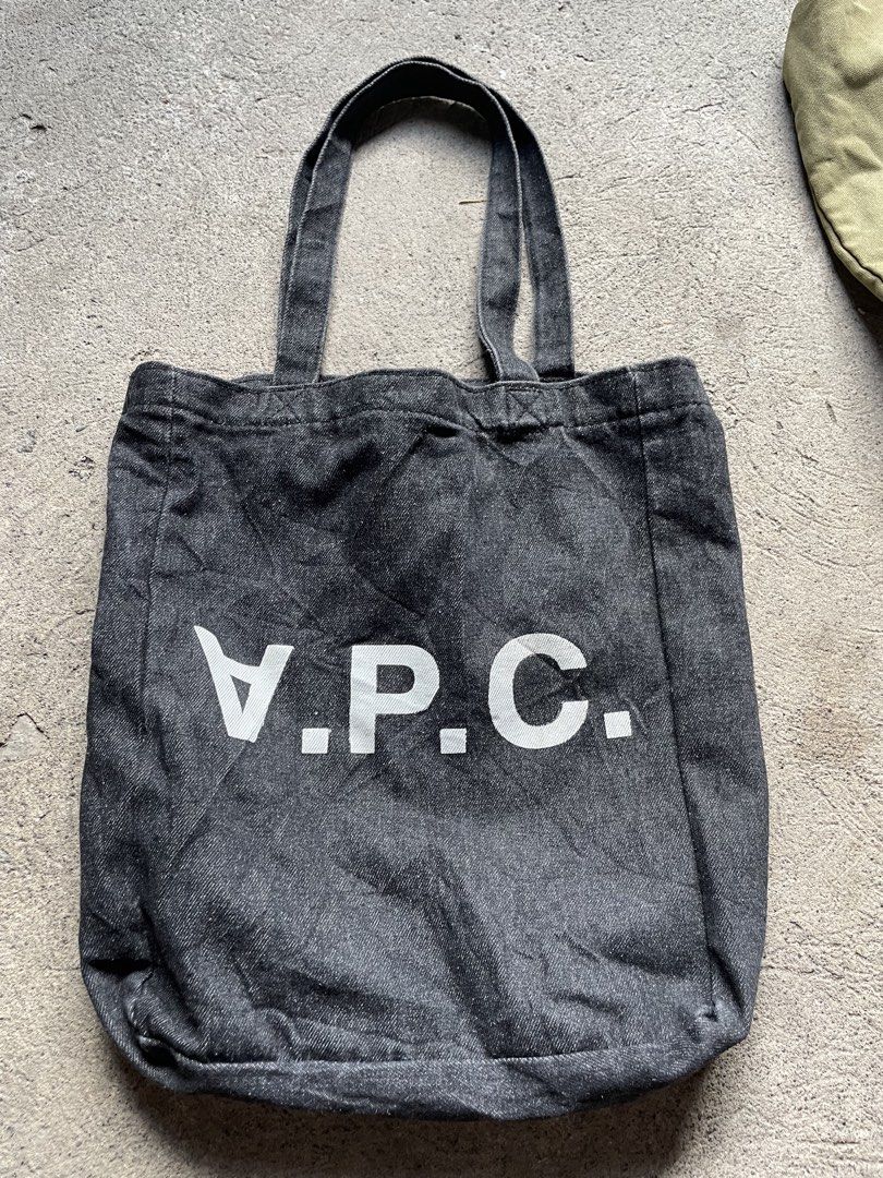 A.P.C. Denim Tote Bag (Category: Tote Bags) located in Siniloan. Submitted by rethr1ft (Listing ID 1464012745, Image 1). Description: - Cut tag - Classic A.P.C. tote bag - Dark denim material - White logo print on front - Simple and functional design - Great for everyday use - Sturdy handles - Plenty of interior space - Easy to carry.