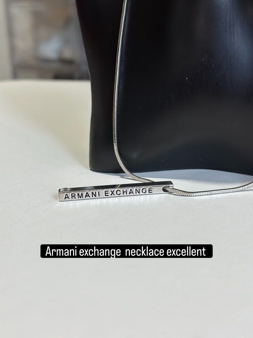 Armani Exchange Bar Necklace Silver Tone (Category: Necklaces) located in Daet. Submitted by thrifthings2018 (Listing ID 1464019853, Image 1). Description: - Armani Exchange necklace - Silver tone bar pendant with engraved brand name - Classic snake chain - Simple and versatile design for everyday or dressing up - Secure clasp closure.