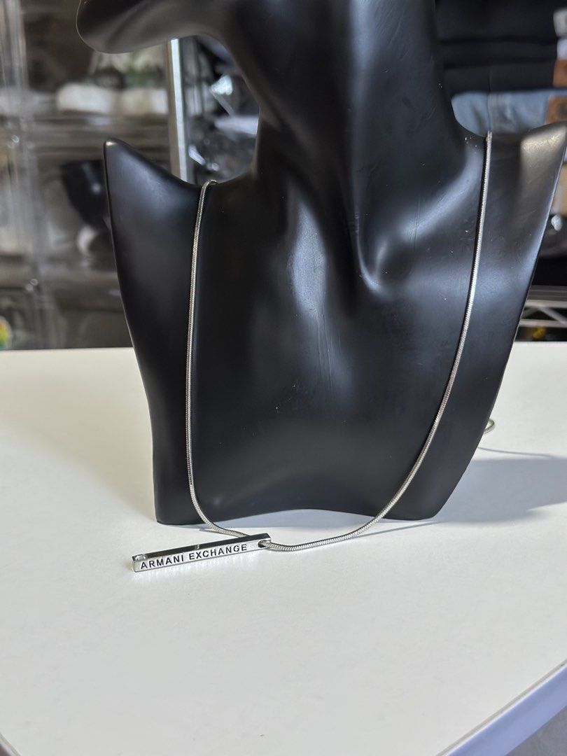 Armani Exchange Bar Necklace Silver Tone (Category: Necklaces) located in Daet. Submitted by thrifthings2018 (Listing ID 1464019853, Image 3). Description: - Armani Exchange necklace - Silver tone bar pendant with engraved brand name - Classic snake chain - Simple and versatile design for everyday or dressing up - Secure clasp closure.