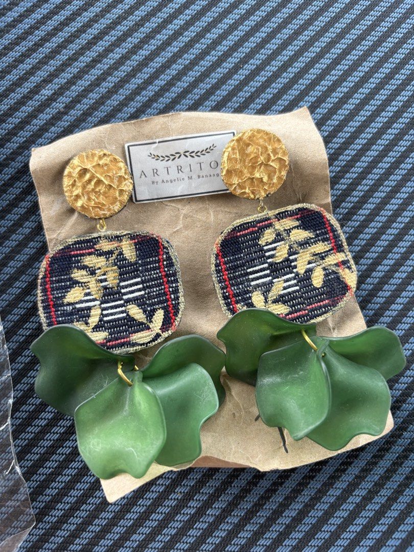 ARTRIOS Gold & Fabric Statement Earrings (Local & Handmade) (Category: Earrings) located in Baguio. Submitted by pinkynj (Listing ID 1464000082, Image 3). Description: - Unique ARTRIOS earrings by designer Angelie M. Banaag. - Features elegant gold textured studs. - Fabric panels with a dark background, detailed with gold and red threads. - Dangling green petal-like accents add a unique touch. - A stunning statement piece to elevate any outfit. -