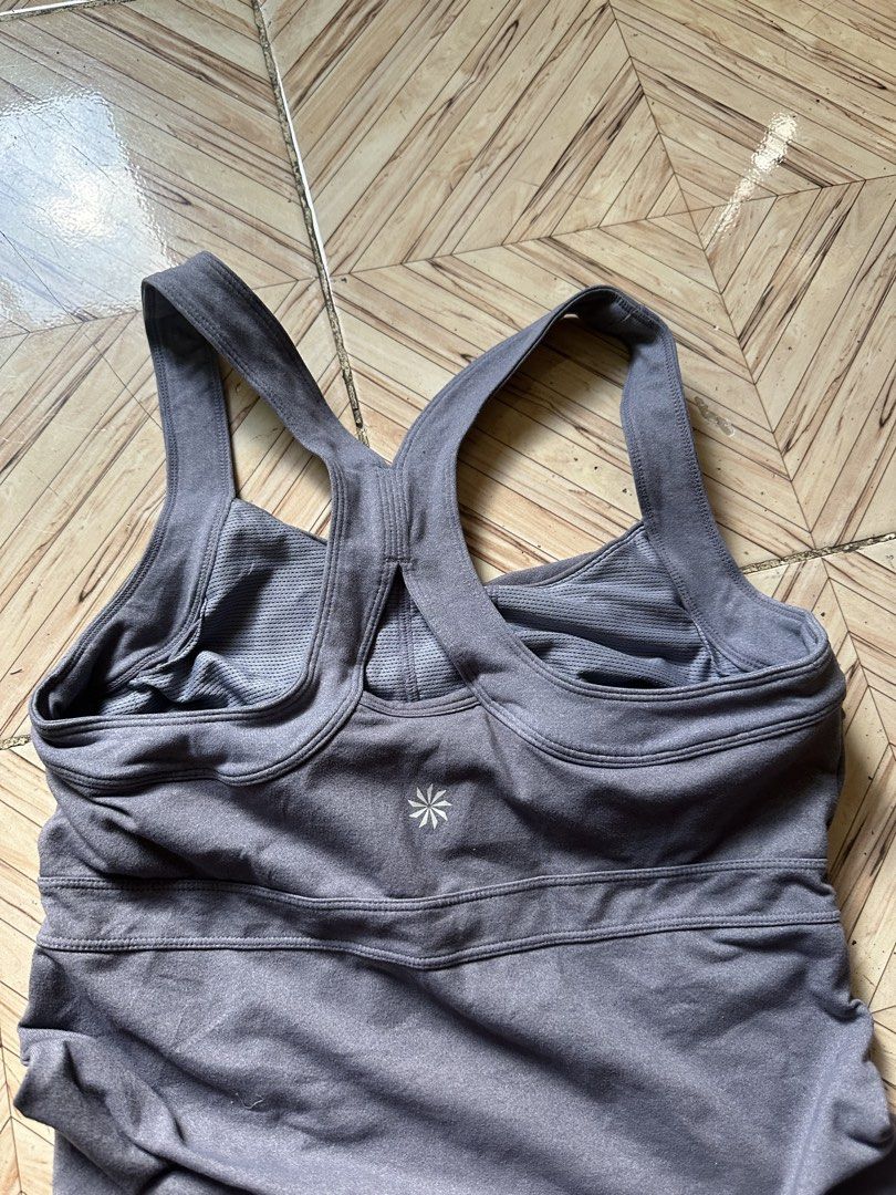 Athleta Twist Front Athletic Tank Top Size M (Category: Sleeveless) located in Angeles City. Submitted by alejeong27 (Listing ID 1463968588, Image 3). Description: - Athleta tank top - Size: Medium - Twist front detail - Racerback design for support - Built-in bra included - Fabric: Nylon, Polyester, Spandex blend (comfortable & stretchy) - Ideal for workouts or casual wear.