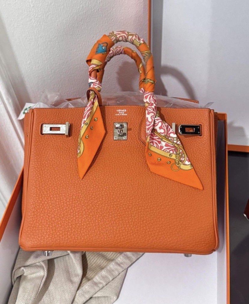 (Authentic) Hermes Birkin 25 (Category: Luxury Bags & Wallets) located in Cordova. Submitted by aux.archive (Listing ID 1463948780, Image 2). Description: Hermes Birkin 25 cm Togo Hermes staple orange Palladium R stamp no enclosure Used few times Dustbag Box Rainkit Carebooklet R stamp no square enclosed.