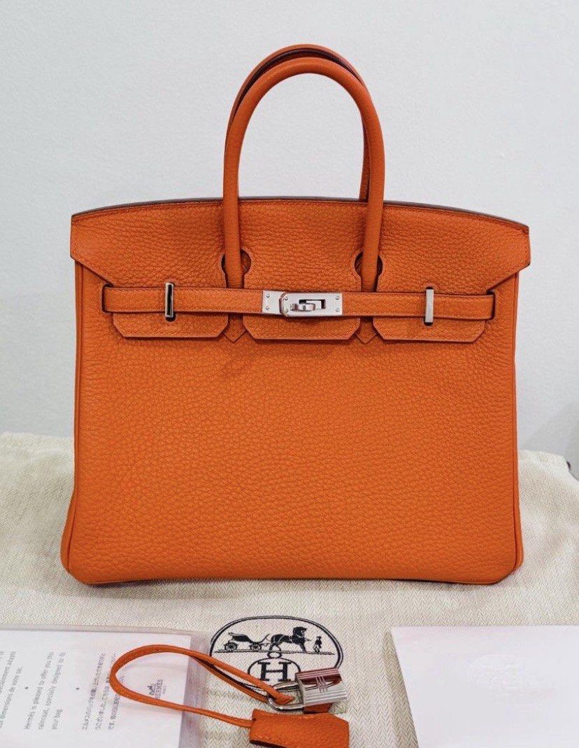 (Authentic) Hermes Birkin 25 (Category: Luxury Bags & Wallets) located in Cordova. Submitted by aux.archive (Listing ID 1463948780, Image 3). Description: Hermes Birkin 25 cm Togo Hermes staple orange Palladium R stamp no enclosure Used few times Dustbag Box Rainkit Carebooklet R stamp no square enclosed.
