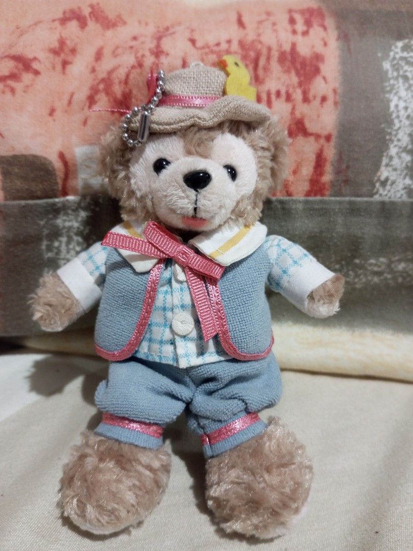 Authentic Tokyo DisneySea Cape Cod 2010 Easter Duffy Plush Badge Keychain" (Category: Plushies & Soft Toys) located in Victorias. Submitted by tobylacua26871 (Listing ID 1464055913, Image 1). Description: - Adorable Duffy the Disney Bear plush toy. - Features a charming blue checkered shirt, vest, and shorts. - Includes a cute little hat. - Stands approximately 15cm tall. - Ideal for Disney collectors or as a thoughtful gift. - Authentically sour