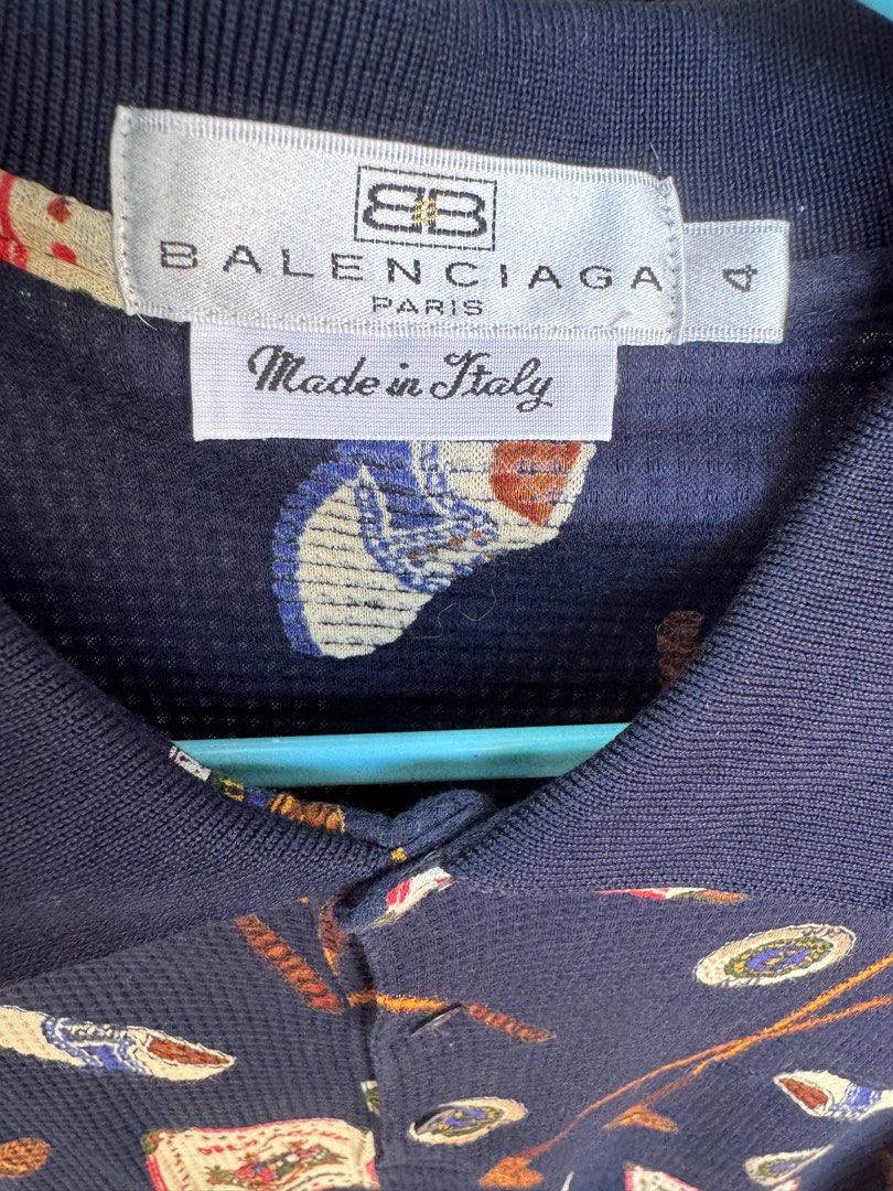 Balenciaga 100% Original (Category: Luxury Apparel) located in Manila. Submitted by wildbear.e10374 (Listing ID 1463958602, Image 1). Description: - Navy blue Balenciaga Paris polo shirt - Features a fun all-over print with golf motifs, clubs, and 'Open Club' graphics - Short sleeves and collared neckline - Made in Italy - Ideal for Occasion or daily Balenciaga collectors.