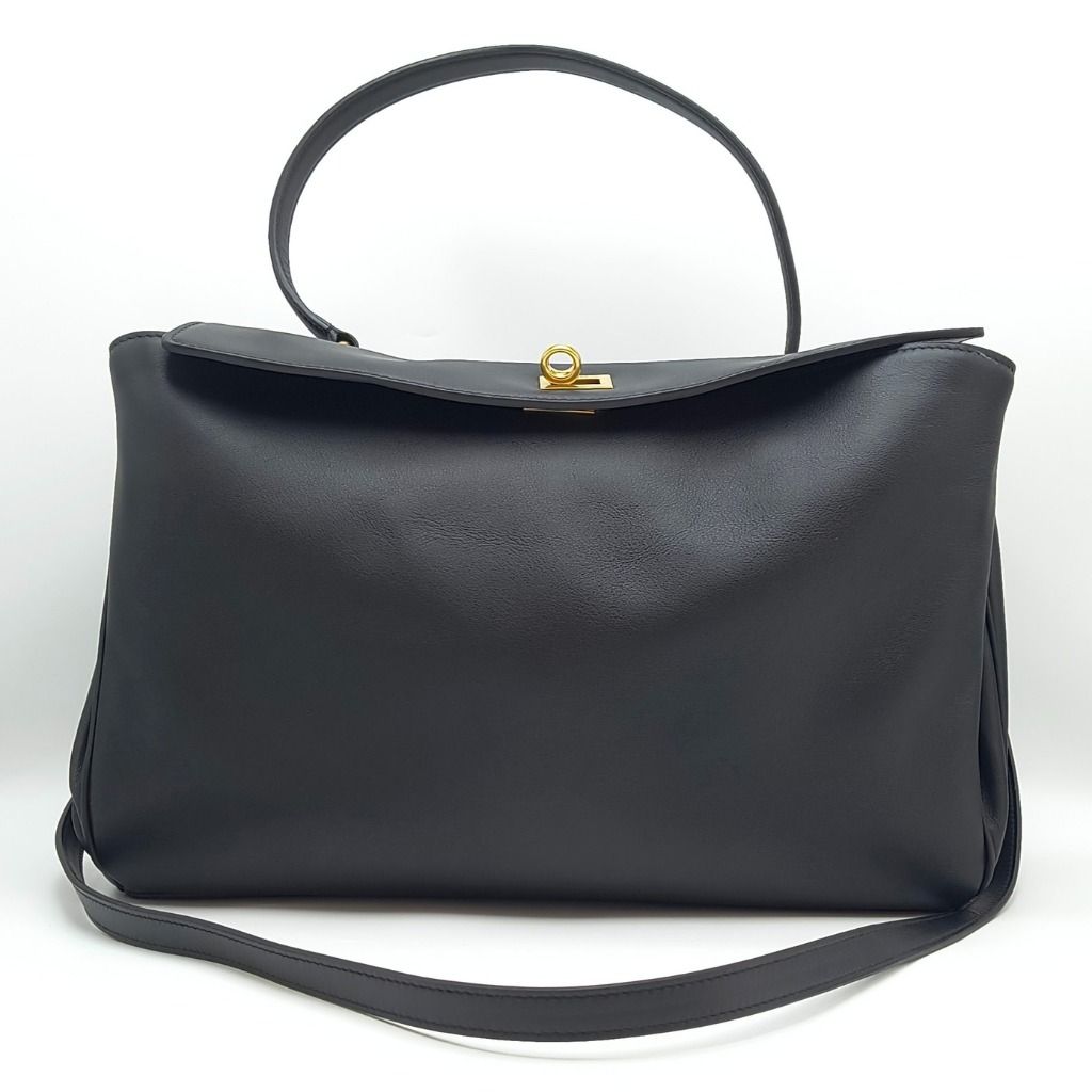 Balenciaga Rodeo Medium Bag Black (Category: Luxury Bags & Wallets) located in Cebu City. Submitted by theluxxaffair (Listing ID 1463987523, Image 3). Description: Balenciaga Rodeo Medium bag in black smooth calfskin leather with aged-gold hardware. Features a top handle, removable shoulder strap, turn-lock closure and wide front pocket. Spacious nappa leather-lined interior with zip and flat pockets. Includes removable leather cloche with split 