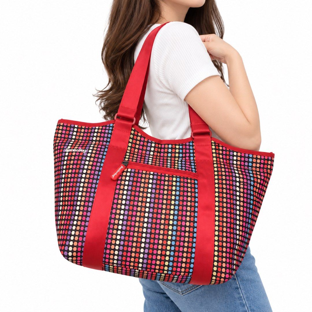 Bamboobag Tote Bag - Colorful Polka Dot & Hexagon Pattern (Category: Tote Bags) located in Carigara. Submitted by spark2503 (Listing ID 1463958200, Image 1). Description: - Fun and vibrant Bamboobag tote - Reversible design: colorful polka dots on one side, hexagon pattern on the other - Eye-catching red straps and zipper details - Multiple zippered compartments for secure storage - Convenient front pocket - Interior mesh pockets for organization