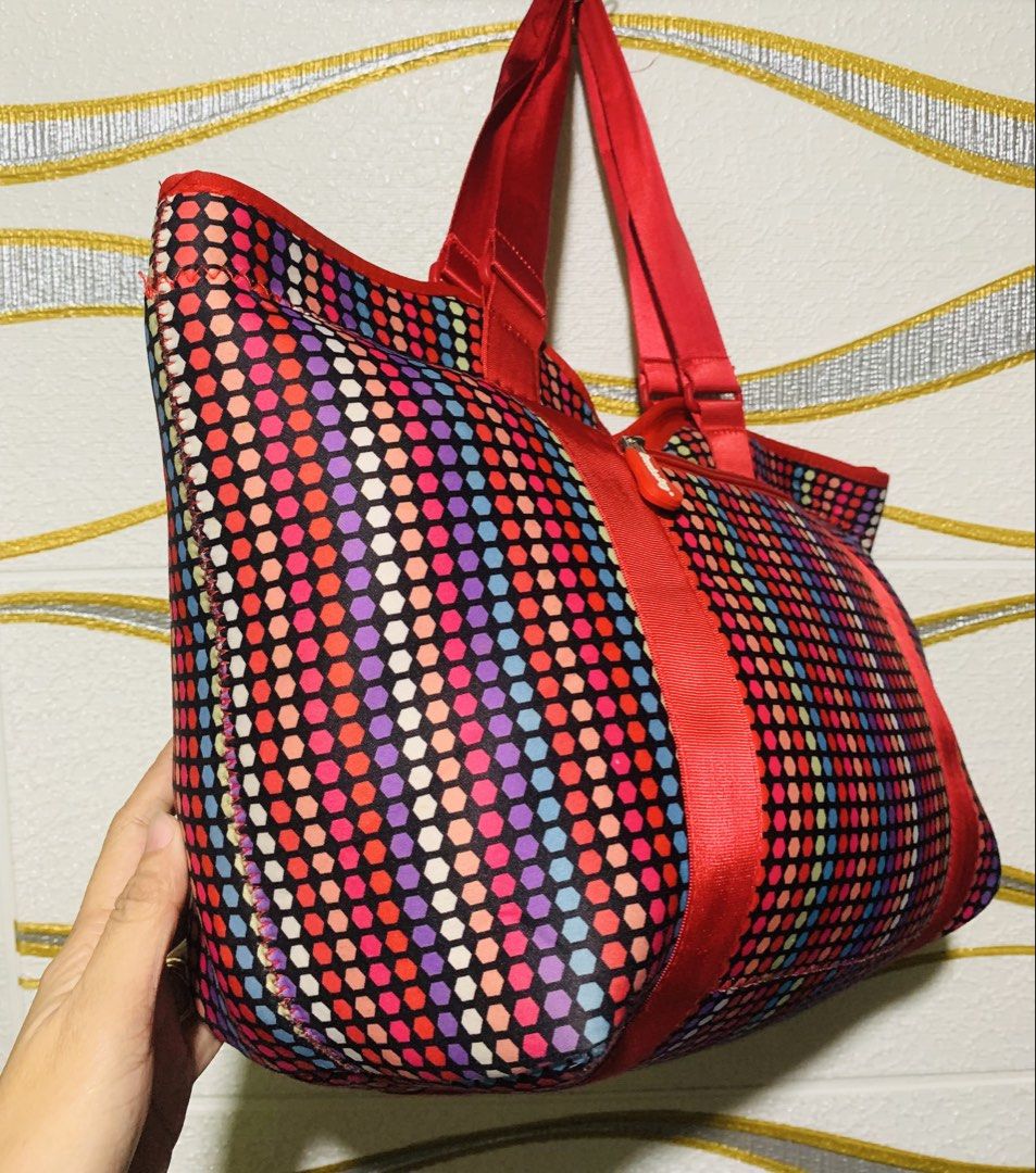 Bamboobag Tote Bag - Colorful Polka Dot & Hexagon Pattern (Category: Tote Bags) located in Carigara. Submitted by spark2503 (Listing ID 1463958200, Image 2). Description: - Fun and vibrant Bamboobag tote - Reversible design: colorful polka dots on one side, hexagon pattern on the other - Eye-catching red straps and zipper details - Multiple zippered compartments for secure storage - Convenient front pocket - Interior mesh pockets for organization