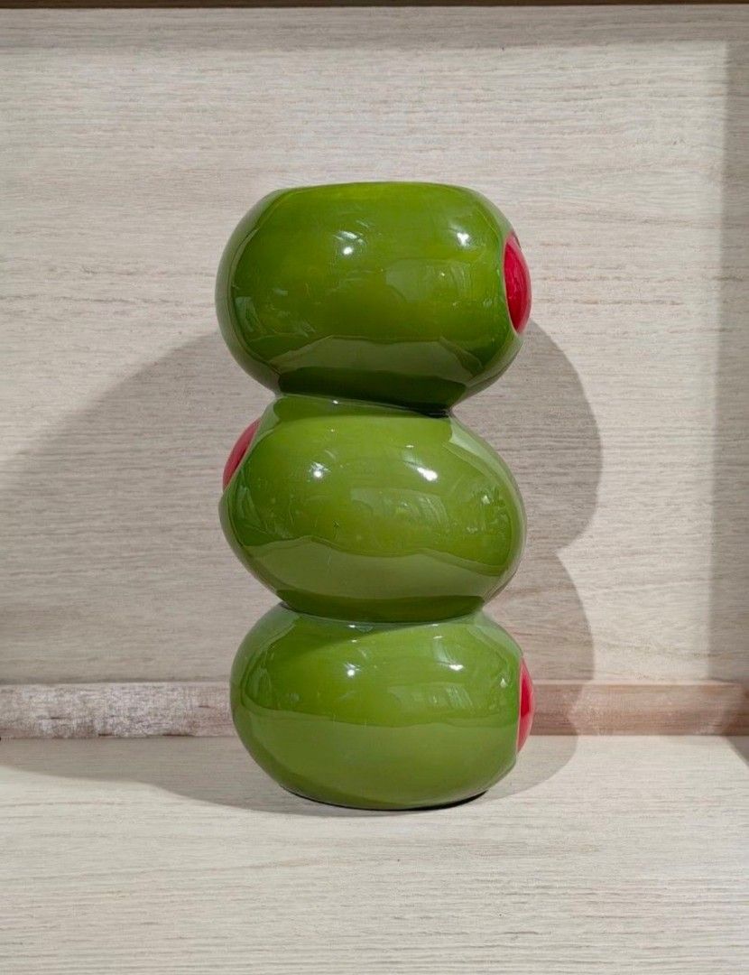 ban.do stacked olives novelty ceramic Vase (Category: Vases & Decorative Bowls) located in Calamba. Submitted by princesspauliney. (Listing ID 1464006747, Image 2). Description: Inspired by cocktail hour, this ceramic flower vase from ban.do features a stacked olive silhouette. Perfect for the maximalist space, use this flower vase for your fresh or dried stems. Features - ban.do Stacked Olive Ceramic Vase - Ceramic flower vase in a kitschy olive