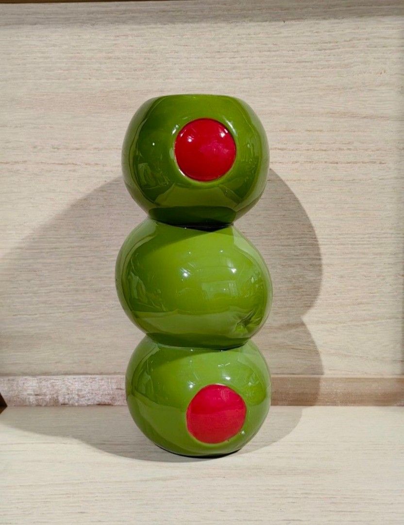 ban.do stacked olives novelty ceramic Vase (Category: Vases & Decorative Bowls) located in Calamba. Submitted by princesspauliney. (Listing ID 1464006747, Image 3). Description: Inspired by cocktail hour, this ceramic flower vase from ban.do features a stacked olive silhouette. Perfect for the maximalist space, use this flower vase for your fresh or dried stems. Features - ban.do Stacked Olive Ceramic Vase - Ceramic flower vase in a kitschy olive
