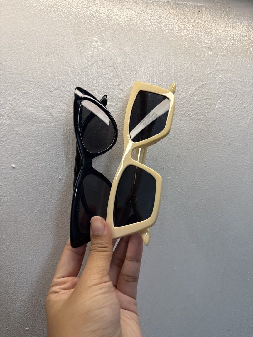 Black and Cream Cat Eye Sunglasses (Category: Sunglasses & Eyewear) located in Mandaluyong City. Submitted by nftp24 (Listing ID 1464094999, Image 1). Description: - Two pairs of chic cat-eye sunglasses - Available colors: Classic Black and Cream - Features dark lenses for excellent sun protection - Perfect for sunny days and adding flair to any outfit - Special bundle deal: Get both pairs for a fantastic price!.