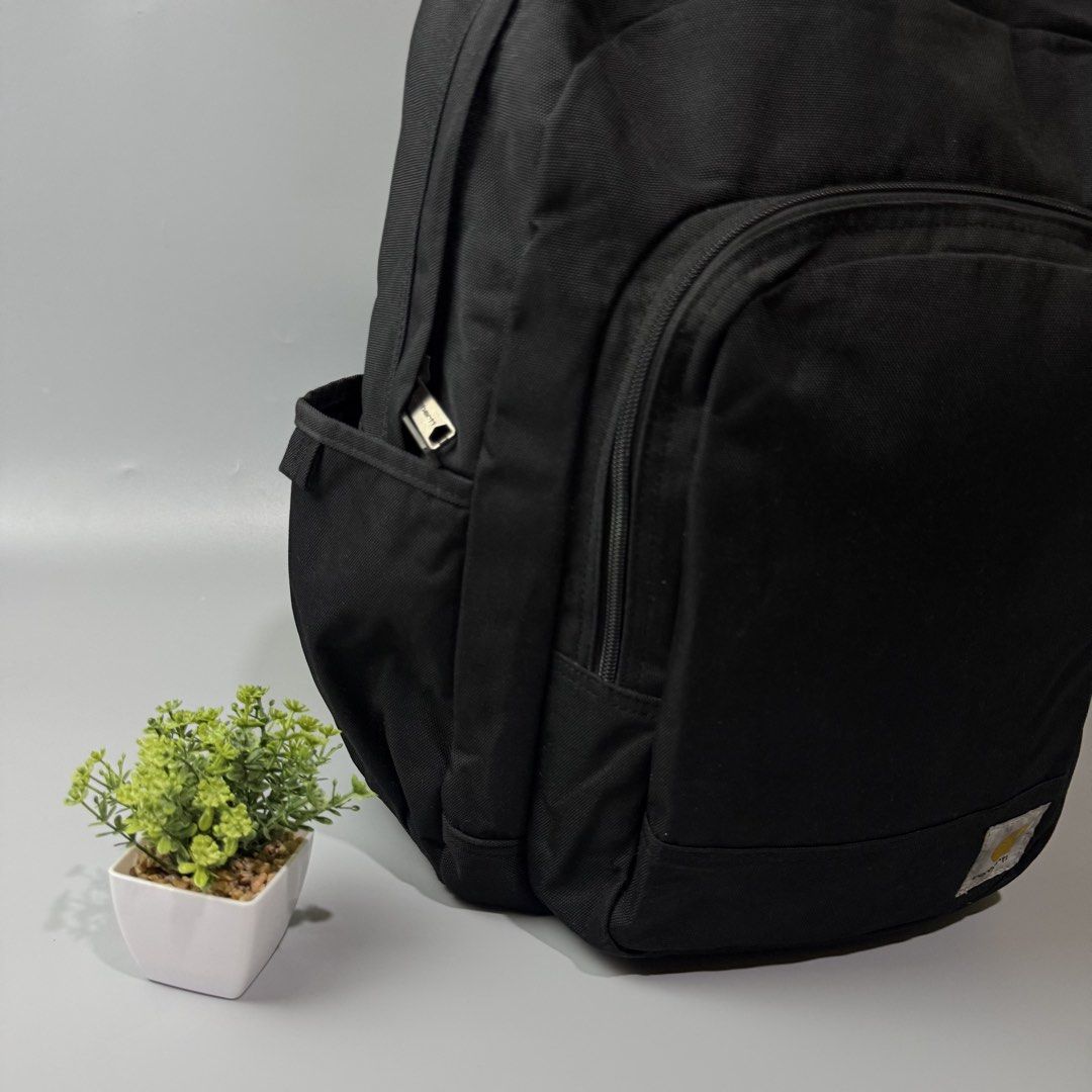 Black Carhartt Backpack (Category: Backpacks) located in Bago City. Submitted by g___shop (Listing ID 1464047129, Image 3). Description: - Classic black Carhartt backpack - Durable canvas material - Spacious main compartment - Front zip pocket - Side pockets for extra storage - Ideal for school or everyday use - Ready for a new owner.
