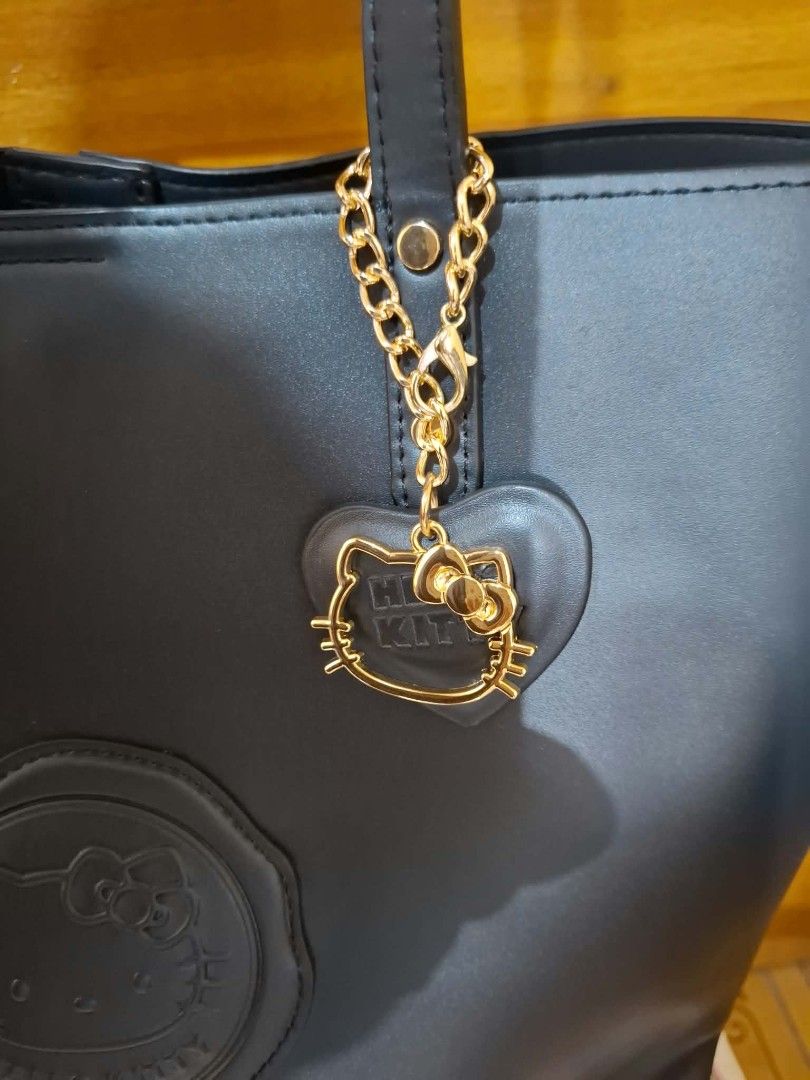 Black Hello Kitty Tote Bag (Category: Tote Bags) located in Muntinlupa City. Submitted by googoosh_collection (Listing ID 1463980552, Image 3). Description: - Hello Kitty black tote bag - Features an embossed Kitty design - Adorned with a cute gold Kitty heart charm - Ample space for your daily essentials - A must-have for any Kitty enthusiast! MOD: Lalamove/ Gogo express (Shipping fee shouldered by the buyer) MOP: Gcash 📍Location: Muntinlupa.