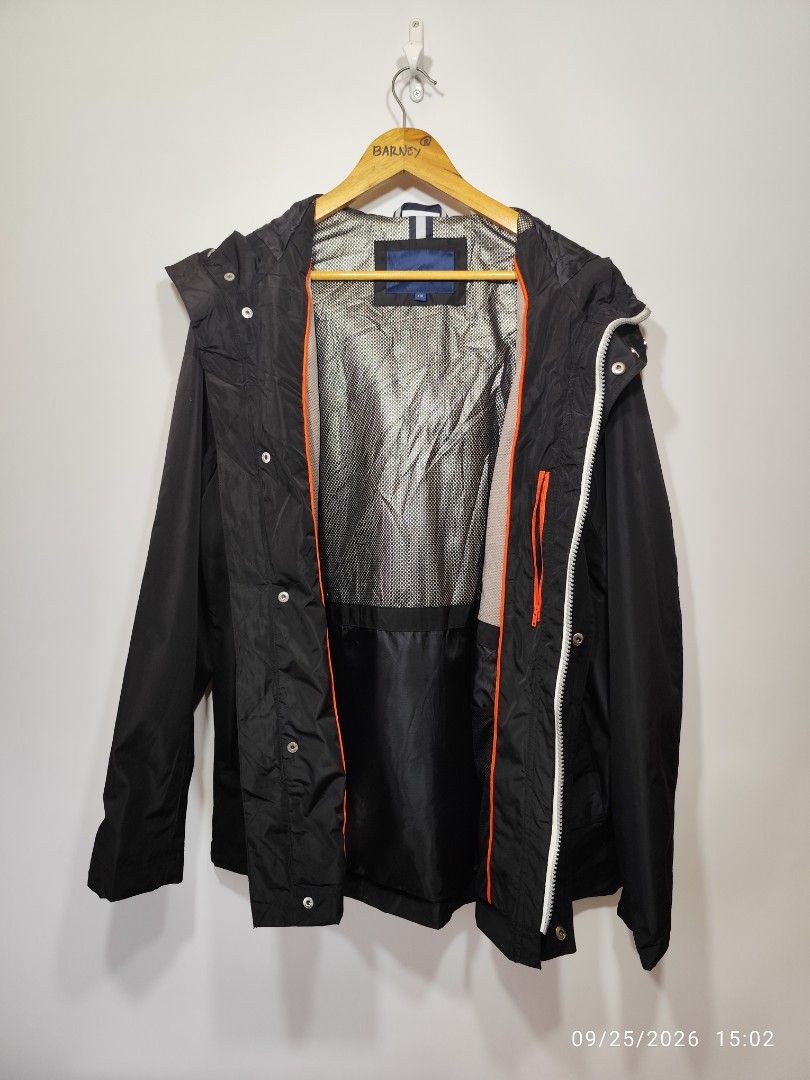 Black Hooded Jacket with Zip and Snap Button Closure (Category: Coats, Jackets and Outerwear) located in San Fernando. Submitted by riasbarney67882 (Listing ID 1463996141, Image 3). Description: - Black hooded jacket - Zip and snap button front closure - Two front pockets with snap buttons - Drawstring hood and hem - Lined interior with orange accents - Great for layering or as outerwear.
