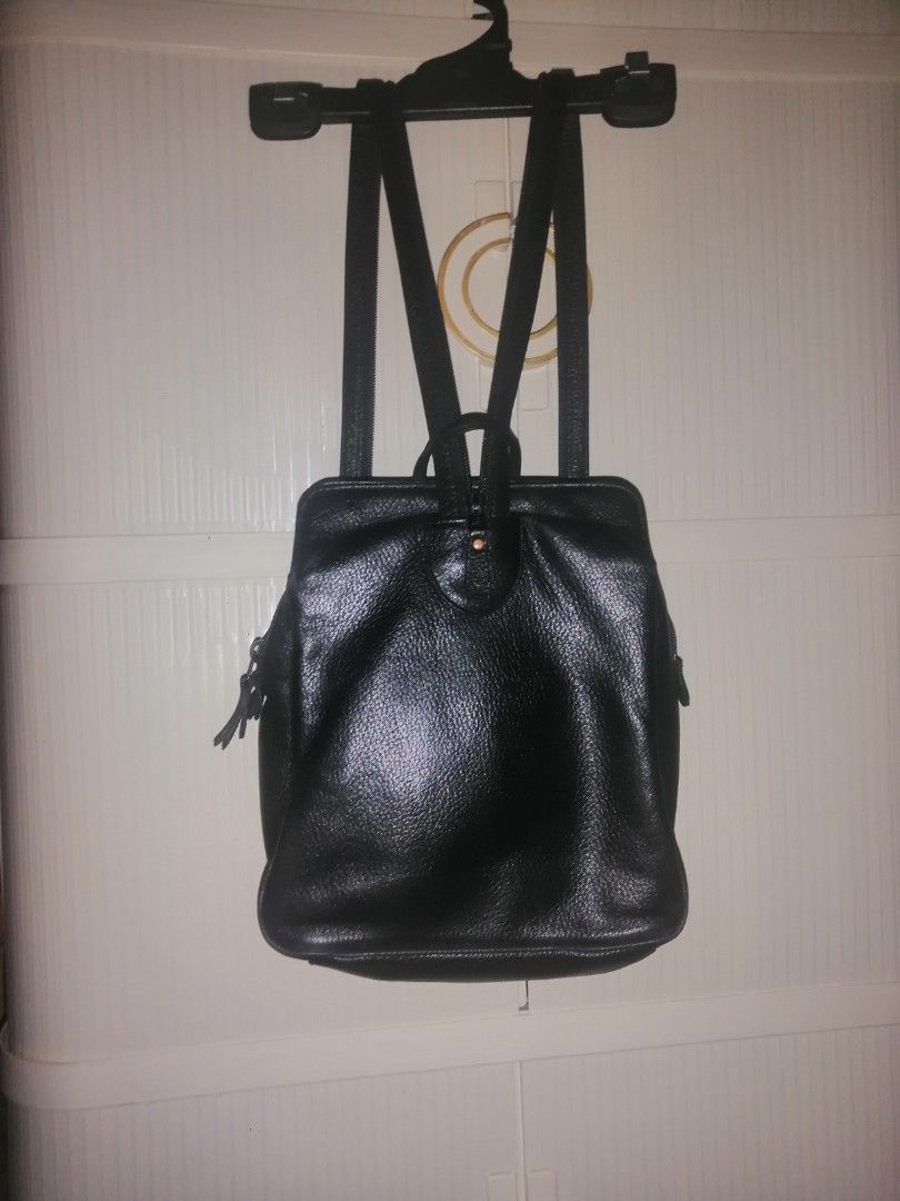 Black Leather Backpack (Category: Backpacks) located in Quezon City. Submitted by rolenalma (Listing ID 1464126107, Image 1). Description: - Genuine black leather backpack - Textured finish for a sophisticated look - Adjustable straps for comfortable wear - Convenient front pocket for quick access - Side zip pockets for extra storage - D-rings at the bottom for versatile strap options - Ideal for everyday use, work, or travel.