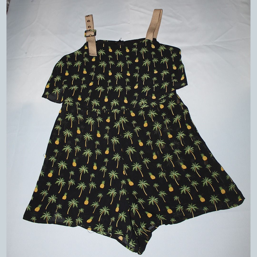 Black Palm Tree and Pineapple Print Romper with Adjustable Straps (Category: Rompers) located in Tanauan. Submitted by arlene_panganiban (Listing ID 1463997791, Image 2). Description: - Cute black romper - Fun palm tree and pineapple print - Adjustable tan straps with buckle details - Off-the-shoulder ruffle detail - Lightweight fabric - Ideal for tropical vacations or casual summer days.
