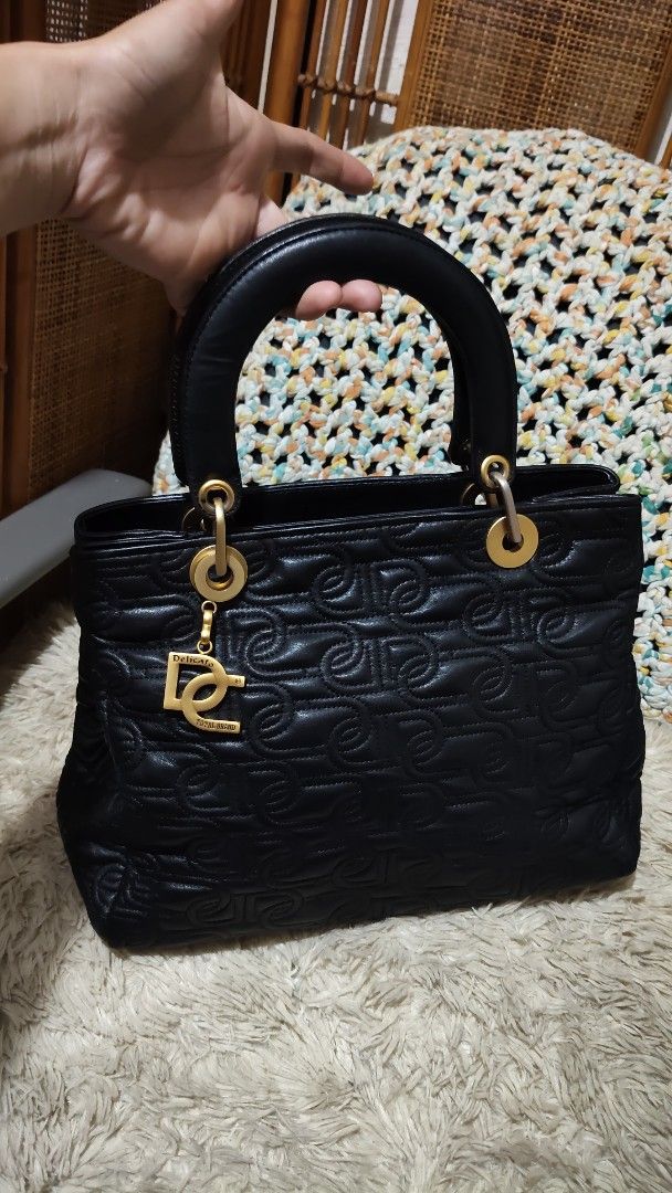 Black Quilted Handbag with DG Charm (Category: Shoulder Bags) located in Cebu City. Submitted by lumaynojes00490 (Listing ID 1463960143, Image 2). Description: - Black quilted handbag - Features repeating DG logo pattern - Includes a gold DG charm - Top handle design - Ideal for everyday use - Chic and stylish.