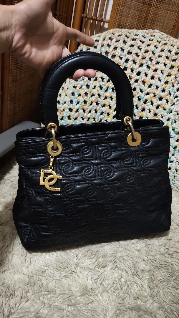 Black Quilted Handbag with DG Charm (Category: Shoulder Bags) located in Cebu City. Submitted by lumaynojes00490 (Listing ID 1463960143, Image 3). Description: - Black quilted handbag - Features repeating DG logo pattern - Includes a gold DG charm - Top handle design - Ideal for everyday use - Chic and stylish.