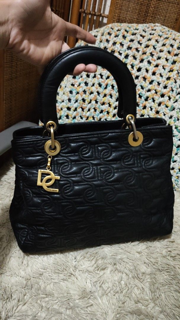 Black Quilted Handbag with DG Charm (Category: Shoulder Bags) located in Cebu City. Submitted by lumaynojes00490 (Listing ID 1463960143, Image 1). Description: - Black quilted handbag - Features repeating DG logo pattern - Includes a gold DG charm - Top handle design - Ideal for everyday use - Chic and stylish.