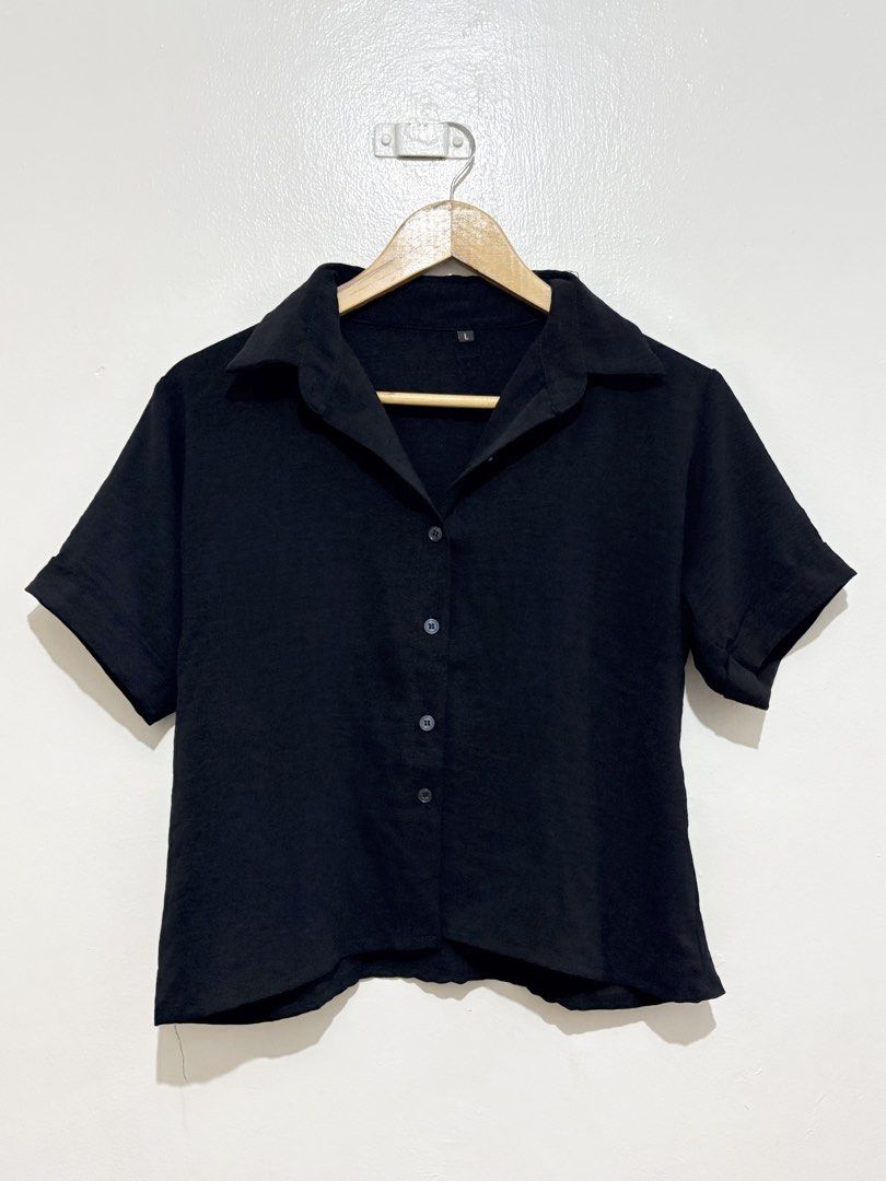 Black Short Sleeve Button Up Polo Blouse (Category: Shirts) located in Caloocan City. Submitted by ashpreloves (Listing ID 1464082338, Image 1). Description: - Classic black short sleeve shirt - Button-up front with collar - Perfect for casual wear or dressing up - Easy to pair with any outfit.