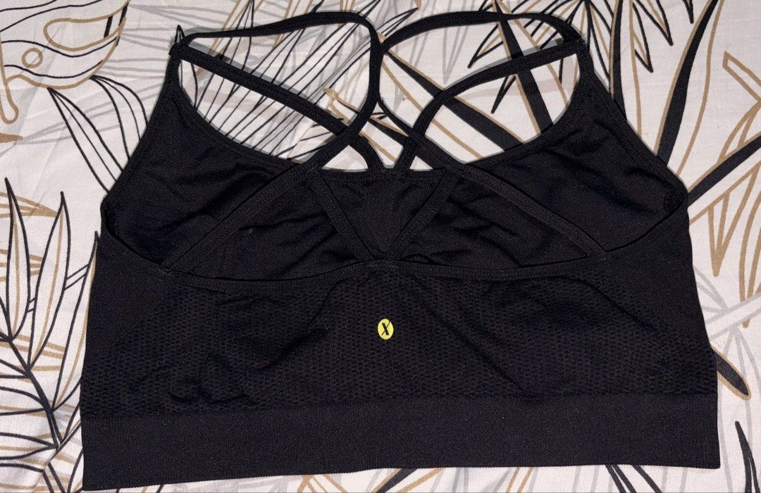 Black Strappy Sports Bra (Category: Activewear) located in Manila. Submitted by keenfox-84bb (Listing ID 1464025062, Image 2). Description: - Seamless black sports bra - Stylish strappy back design - Comfortable elasticated bottom band - Ideal for workouts and everyday use - Features the 'X' brand logo.