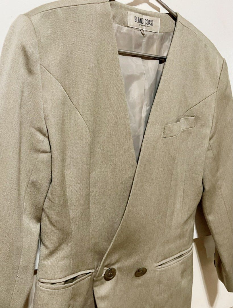 Blanc Coast Beige V-Neck Double-Breasted Blazer (Category: Coats, Jackets and Outerwear) located in Bulacan. Submitted by grazcloset (Listing ID 1464057753, Image 2). Description: - Beige blazer from Blanc Coast - V-neckline - Double-breasted button closure - Two front pockets - Chest pocket detail - Lined interior - Button details on cuffs - Ideal for smart casual or office wear Best Fit : M-L.