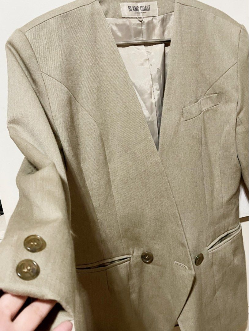 Blanc Coast Beige V-Neck Double-Breasted Blazer (Category: Coats, Jackets and Outerwear) located in Bulacan. Submitted by grazcloset (Listing ID 1464057753, Image 3). Description: - Beige blazer from Blanc Coast - V-neckline - Double-breasted button closure - Two front pockets - Chest pocket detail - Lined interior - Button details on cuffs - Ideal for smart casual or office wear Best Fit : M-L.