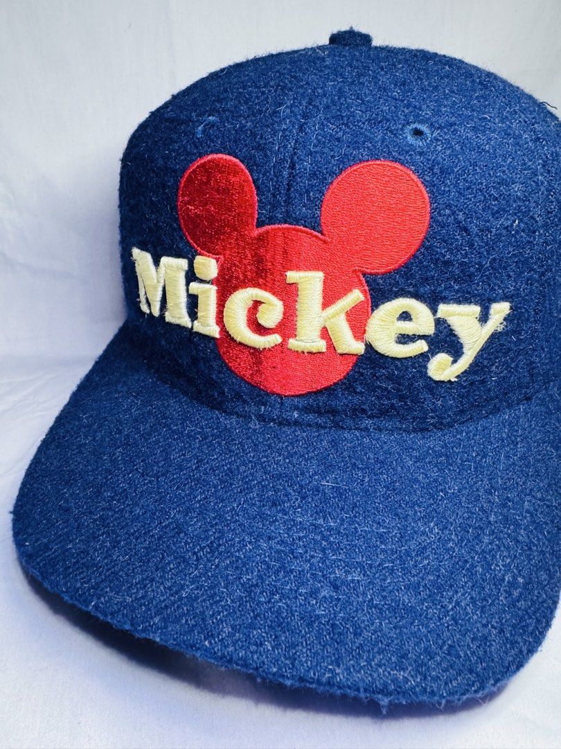 Blue Mickey Mouse Baseball Cap (Category: Caps & Hats) located in Roxas City. Submitted by patsquarephantz (Listing ID 1463991570, Image 2). Description: - Classic blue baseball cap - Features a red Mickey Mouse logo and 'Mickey' embroidery - Adjustable strap at the back for a custom fit - Fabric shows some texture - Perfect for casual wear and Disney enthusiasts - A fun addition to any outfit.