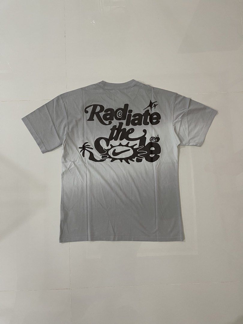 Bnew nike tees freeshippinv nationwide (Category: Tshirts & Polo Shirts ) located in Tarlac. Submitted by swoosh_garmentz (Listing ID 1464042477, Image 2). Description: - Grey Nike T-shirt - Features a 'Radiate the Sun' graphic print on the back - Small Nike logo on the front chest - Estimated size: Medium - Ideal for casual outfits.