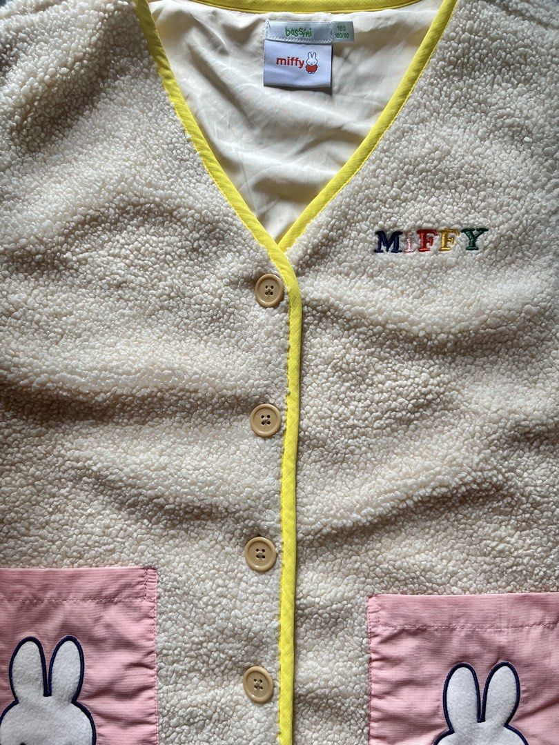 Bossini Miffy Fleece Vest (Category: Sleeveless) located in Valenzuela. Submitted by shiiionsight (Listing ID 1464035484, Image 3). Description: - Adorable Bossini Miffy fleece vest - Cream color with cheerful yellow trim - Features two cute pink pockets with Miffy embroidery - "Miffy" lettering across the chest - Easy front button closure - Ideal for layering to stay cozy.