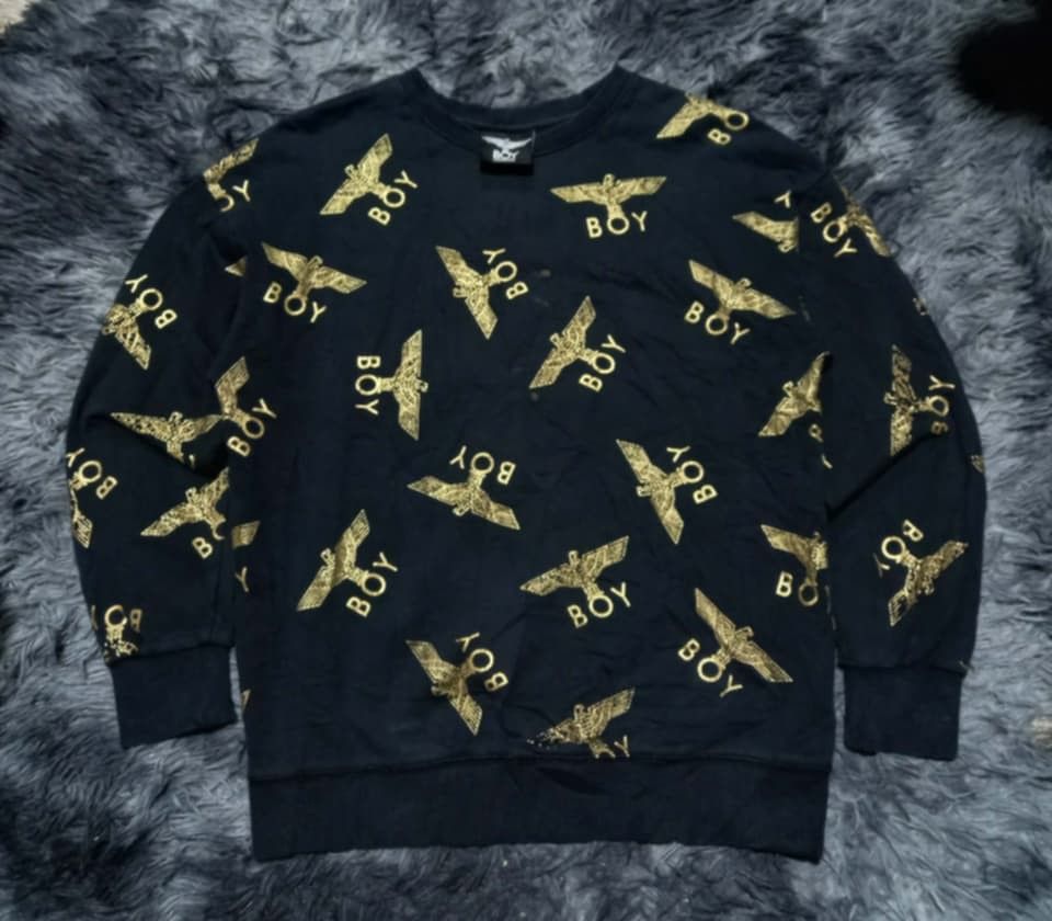 BOY London All Over Print Eagle Sweatshirt (Category: Coats, Jackets and Outerwear) located in Iloilo. Submitted by yoleomf6969 (Listing ID 1463943994, Image 1). Description: - Black sweatshirt - All-over gold eagle and BOY logo print - Long sleeves - Crew neck - Great statement piece.