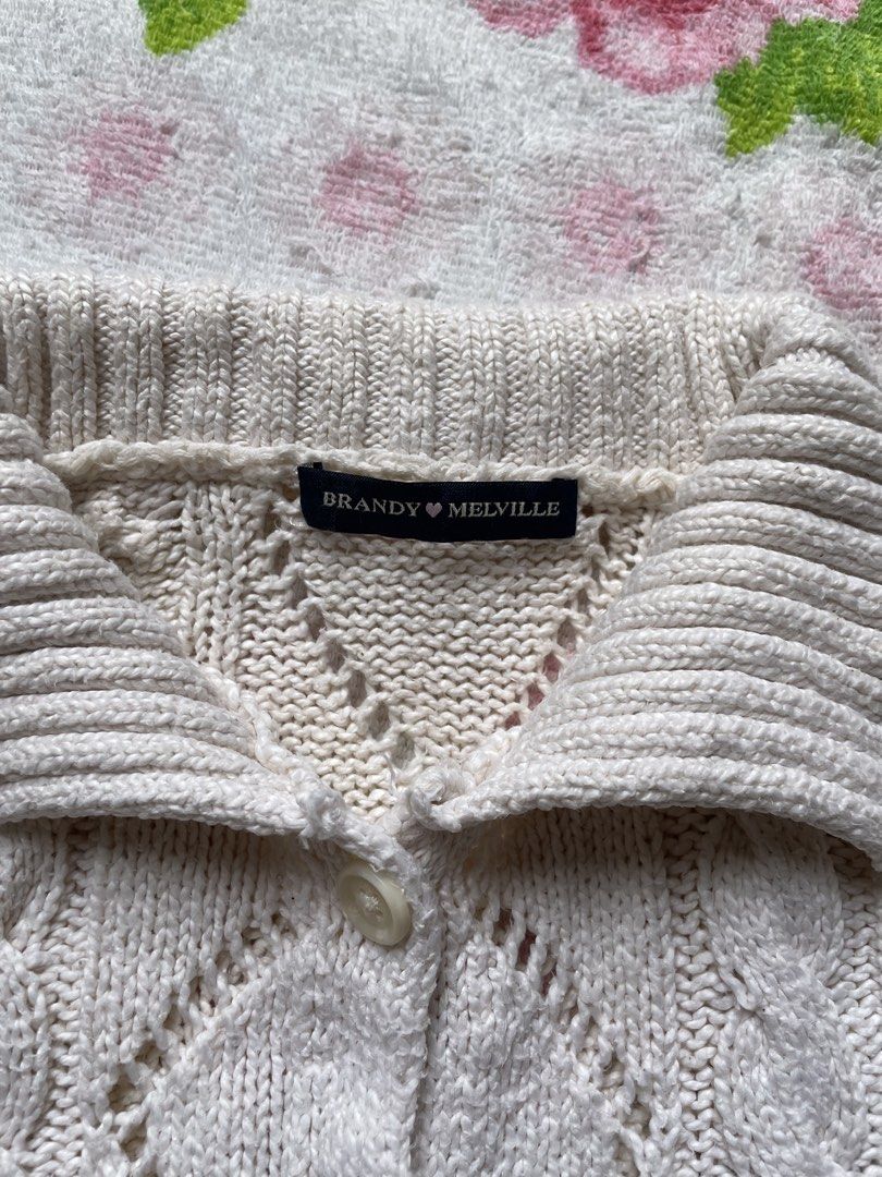 Brandy Melville Cream Cable Knit Collared Cardigan (Category: Coats, Jackets and Outerwear) located in Siniloan. Submitted by rethr1ft (Listing ID 1463968069, Image 2). Description: - Cream colored Brandy Melville cardigan - Cable knit pattern with diamond cutouts - Collared neckline with button closure - Long sleeves with ribbed cuffs - Minor faint marks on the front (please check photos) - Ideal for layering.