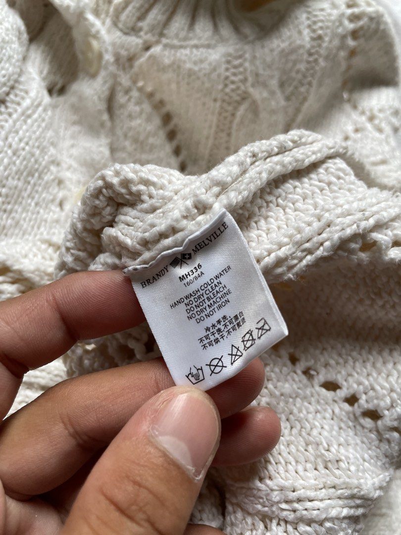 Brandy Melville Cream Cable Knit Collared Cardigan (Category: Coats, Jackets and Outerwear) located in Siniloan. Submitted by rethr1ft (Listing ID 1463968069, Image 3). Description: - Cream colored Brandy Melville cardigan - Cable knit pattern with diamond cutouts - Collared neckline with button closure - Long sleeves with ribbed cuffs - Minor faint marks on the front (please check photos) - Ideal for layering.