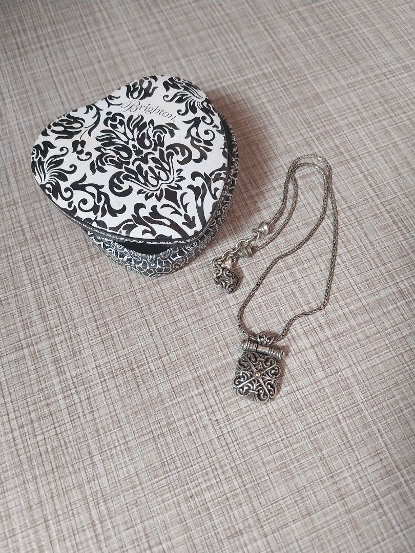 Brighton Silver Scrolled Square Rolled bar Necklace with Original Box (Category: Accessory Holder, Box & Organizers) located in Manila. Submitted by j.dlh (Listing ID 1463987772, Image 1). Description: - Silver-tone chain necklace with decorative pendant -Heart-shaped tin case from Brighton - Features a black and white damask pattern - Quote from Brighton on the inside lid -Original brighton from USA.
