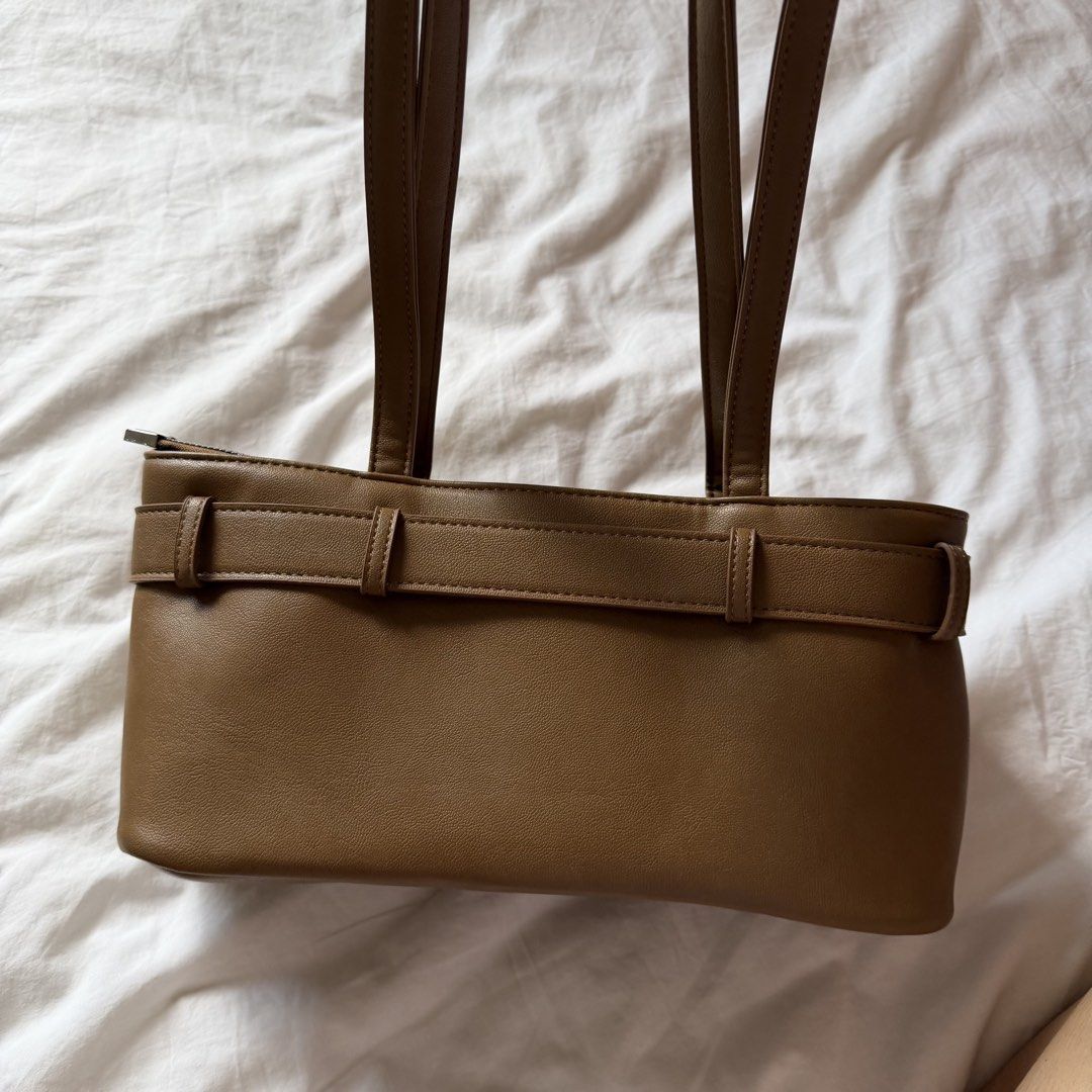 Brown Baguette Bag (Category: Shoulder Bags) located in Mabalacat. Submitted by pauwieee12 (Listing ID 1463958777, Image 3). Description: - Stylish brown shoulder bag - Lipstick stain (last photo) - Made from durable faux leather - Features an attractive front buckle detail - Secure zipper closure for top access - Interior lined with a classic striped pattern - Spacious enough to hold all your essentials - Ideal for everyday use and versatile sty