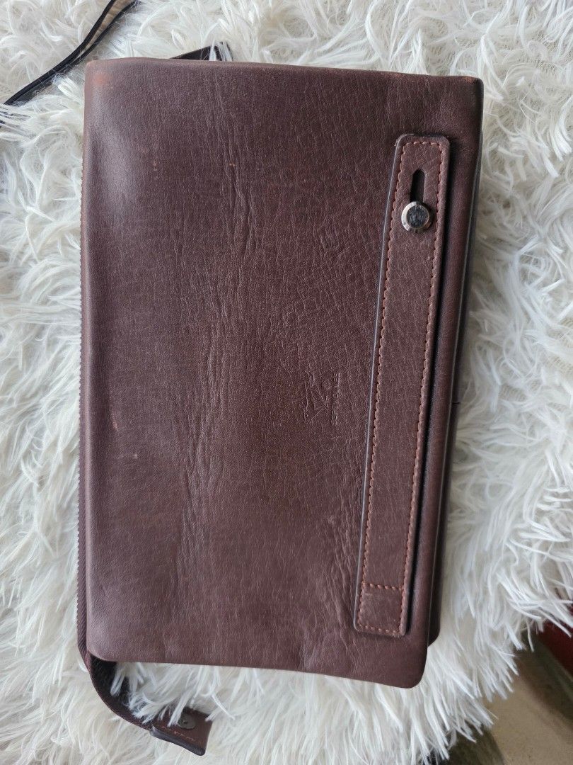 Brown Leather Clutch Bag (Category: Clutches) located in Agoncillo. Submitted by vinsoy07 (Listing ID 1463985849, Image 2). Description: - Genuine brown leather clutch - Secure all-around zipper closure - Multiple interior compartments and card slots - Compact size: approx. 9 inches x 5.5 inches - Perfect for organizing your essentials - Wrist strap attachment point included.