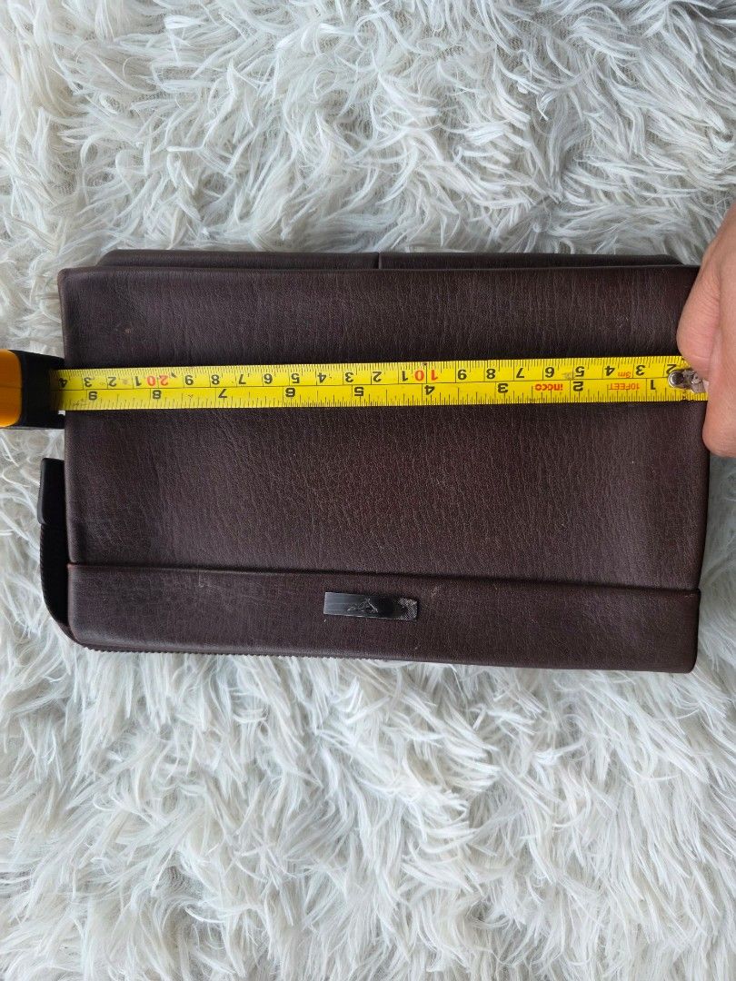 Brown Leather Clutch Bag (Category: Clutches) located in Agoncillo. Submitted by vinsoy07 (Listing ID 1463985849, Image 1). Description: - Genuine brown leather clutch - Secure all-around zipper closure - Multiple interior compartments and card slots - Compact size: approx. 9 inches x 5.5 inches - Perfect for organizing your essentials - Wrist strap attachment point included.