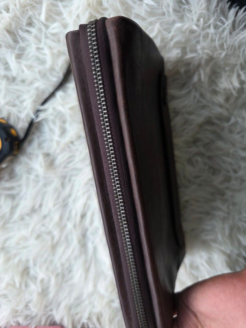 Brown Leather Clutch Bag with Zipper (Category: Clutches) located in Lemery. Submitted by venus23 (Listing ID 1463950341, Image 3). Description: - Genuine brown leather clutch - Secure main zipper closure - Multiple interior compartments for organization - Beautiful leather texture - Approximately 9 inches in length - Ideal for carrying your daily essentials.